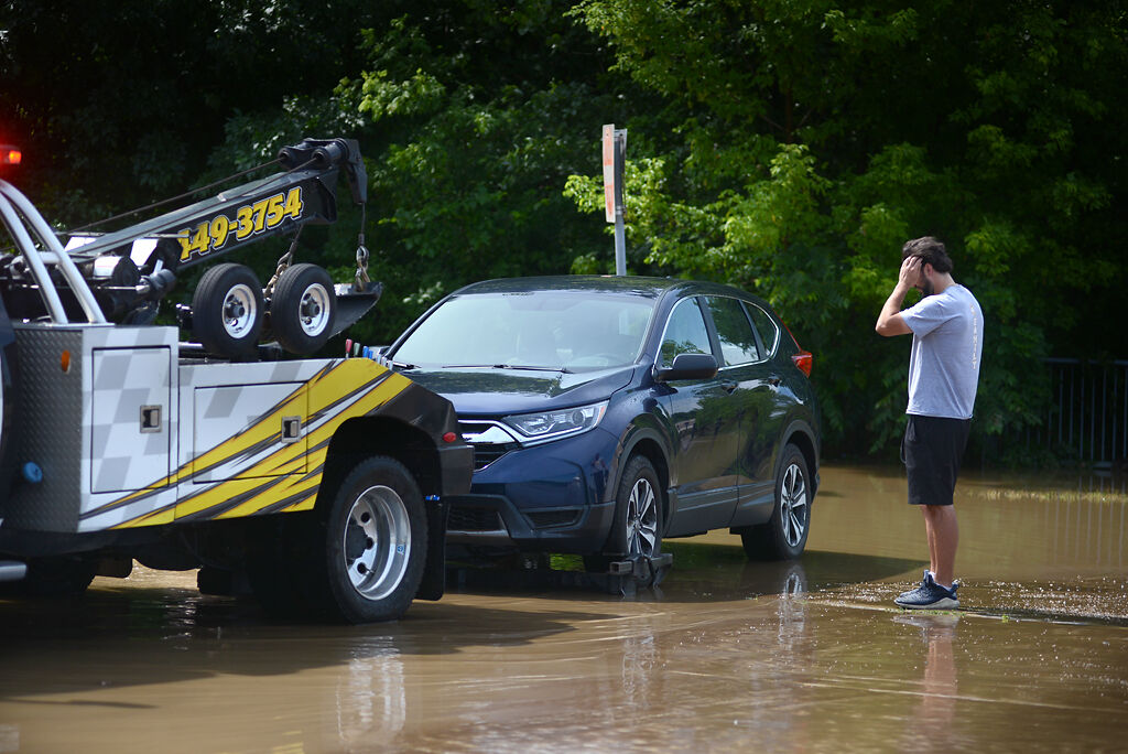 A driver stares at his flooded car